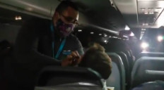 In this viral video, a flight attendant applies duct tapes to an unruly passenger of Frontier Airlines.