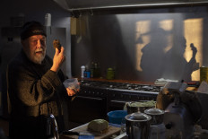 Volker Miros, founder of Woodford Truffles, holds up a Black Winter Perigord truffle, as he prepares food in the kitchen on the family farm, where the truffles are cultivated, close to the town of Ceres, in the Western Cape Province, on July 15, 2021.