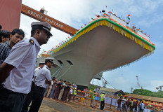 Indian naval officers stand guard during the launch of the indigenously-built aircraft carrier INS Vikrant at the Cochin Shipyard in Kochi on August 12, 2013. India launched its first indigenously-built aircraft carrier on August 12, 2013, a landmark moment in the 5 billion dollar project that seeks to project the country's power and check the rising influence of China. 