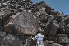 Ibrahim Dabale, 50, a native and art guardian, narrates on ancient depictions of wildlife and other cultural practices, characteristic of the time etched into volcanic rock and now conserved on a jagged rocky outcrop at the remote Abourma Rock Art site in the Makarassou Massif of Tadjoura Region, nothern Djibouti on April 13, 2021.