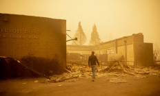 California Governor Gavin Newsom surveys a burned United States Post Office in downtown Greenville, California on August 7, 2021. The Dixie Fire has now ravaged 446,723 acres in four counties, up from the previous day's 434,813. That area is larger than Los Angeles -- and has surpassed the sweep of the vast Bootleg Fire in southern Oregon.
