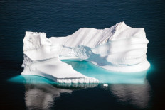  In this file photo taken on August 15, 2019 an aerial photo taken on August 15, 2019 shows an iceberg as it floats along the eastern cost of Greenland near Kulusuk (aslo spelled Qulusuk). Rising global temperature, rising sea levels, intensification of extreme events... The publication of the report of the Intergovernmental Panel on Climate Change (IPCC) is scheduled on August 9.