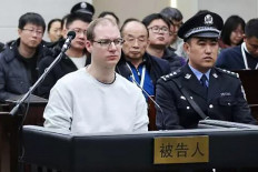 This handout photograph taken and released by the Intermediate Peoples' Court of Dalian on January 14, 2019 shows Canadian Robert Lloyd Schellenberg (front left) during his retrial on drug trafficking charges in the court in Dalian in China's northeast Liaoning province. A Chinese court on August 10, 2021 upheld the death sentence passed on Canadian citizen Robert Lloyd Schellenberg for drug smuggling -– one of a number of ongoing cases that has triggered a severe downturn in relations between Ottawa and Beijing.