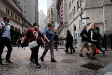 People walk by the New York Stock Exchange (NYSE) in New York City, United States, on Aug. 10, 2021. Asian markets fluctuated Thursday after a record lead from Wall Street.