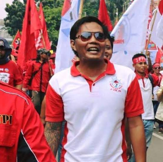 Fighting for human rights: Imam Syafi'i (center, with sunglasses) marches with other fishermen at a May Day rally in 2018.