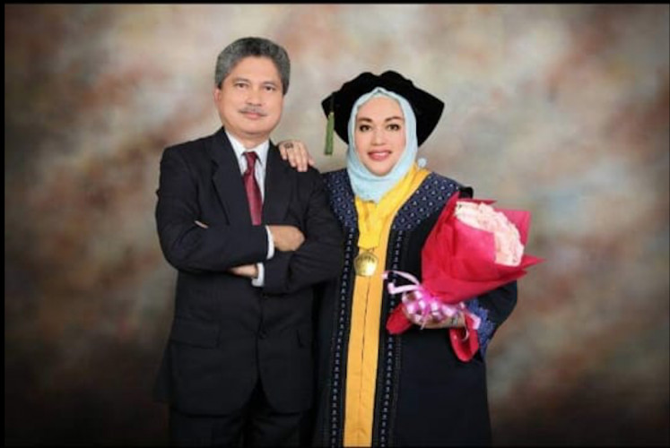 Together: Novilia Sjafri Bachtiar (Right) and her husband at her graduation.