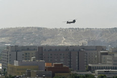 A US military helicopter is pictured flying above the US embassy in Kabul on August 15, 2021.
