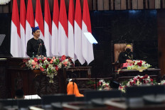 President Joko Widodo (left) delivers the State of the Union Address in traditional Baduy attire as Vice President Ma'ruf Amin (right) looks on, dressed in traditional Mandarese attire, on Aug. 16, 2021 at the legislative complex in Senayan, Jakarta.