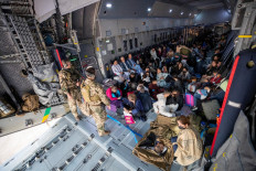 A handout photo obtained from Twitter via @Bw_Einsatz on August 17, 2021 shows evacuees from Afghanistan as they arrive in an Airbus A400 transport aircraft of the German Air Force Luftwaffe in Tashkent, Uzbekistan. 