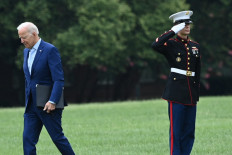 US President Joe Biden past a member of the military after arriving at Fort McNair in Washington, DC on August 16, 2021, after returning early from Camp David. 