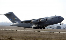 An US Airforce C17 aircraft loaded with French armoured vehicles and soldiers takes off Istres military airport (BA 125) on January 24, 2012, heading toward Mali as part of the 