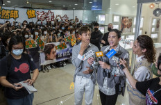 This picture taken on August 5, 2021, shows Anson Kong (C), Lok Man Yeung (2nd R) and Tiger Yau (R), members of Cantopop boyband Mirror, speaking with the media during an event at a shooping mall in Hong Kong.