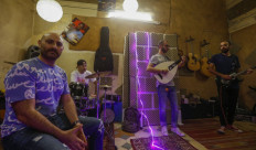 A picture taken on August 13, 2021 in Damascus shows the Safar Musical band, creators of the video for the song "Ya Weel Weely", which topped five million views on YouTube within days of its release and was shot entirely in a small room lit by battery-powered devices.