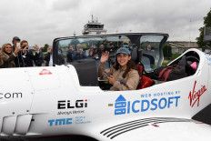 British-Belgian pilot Zara Rutherford, 19, waves before taking off for a round-the-world trip in a light aircraft, in bid to become the youngest woman to fly solo round-the-world in Wevelgem on August 18, 2021.