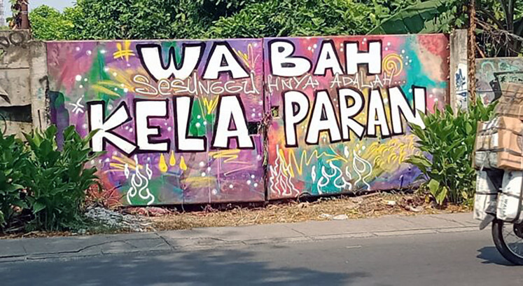Graffiti saying, Wabah sesungguhnya adalah kelaparan (The real plague is hunger), is seen in Ciledug, Tangerang, Banten, before it was painted over. 