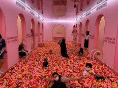 Visitors play in a 'sprinkle pool' at the Museum of Ice Cream in Singapore, August 19, 2021. 



