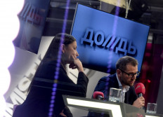 In this file photo taken on February 4, 2014 Co-owners of cable channel Dozhd (TV Rain), Natalya Sindeyeva (L) and Alexander Vinokurov (R) attend a press conference at the channel office in Moscow.