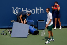 Daniil Medvedev of Russia reacts after colliding with a television camera in his match against AAndrey Rublev of Russia during the semifinals of the Western & Southern Open at Lindner Family Tennis Center on August 21, 2021 in Mason, Ohio. 