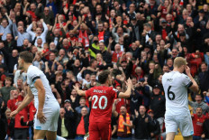 Liverpool's Portuguese striker Diogo Jota (center) celebrates scoring his team's first goal during the English Premier League football match between Liverpool and Burnley at Anfield in Liverpool, north west England on August 21, 2021.
