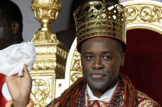 Prince Tsola Emiko waves after being crowned as the 21st king or the Olu of Warri kingdom and the Ogiame Atuwatse 111 during his coronation at Ode Itsekiri on August 21, 2021.