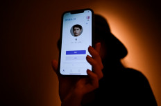 This picture taken on July 16, 2021 shows Melissa showing her virtual boyfriend - a chatbot created by XiaoIce, a cutting-edge artificial intelligence system designed to create emotional bonds its user - on her mobile phone in Beijing.