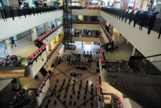 Limited capacity: A shopping mall in Bogor, West Java, prepares to welcome back visitors following the easing of public activity restrictions (PPKM) from level 4 to level 3 on Saturday. Only vaccinated visitors are allowed to enter malls, which can operate at a limited capacity.