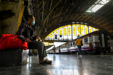 This photo taken on June 22, 2021 shows a commuter waiting for a train at Bangkok Railway Station, more commonly known as Hua Lamphong, in Bangkok.