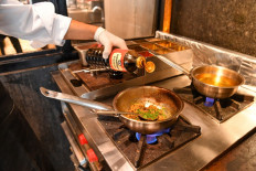 In this picture taken on July 16, 2021 a chef prepares a samosa filling with mince meat with Kikkoman Soy Sauce at the Ishaara restaurant in Mumbai.