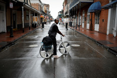 A man rides a bicycle in Bourbon Street at the French Quarter ahead of Hurricane Ida, in New Orleans, Louisiana, US, on Aug. 29, 2021.