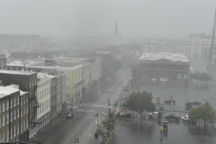 Rain batters N Peters Street in New Orleans, Louisiana, with St. Louis Cathedral visible in the distance (back left) on August 29, 2021 after Hurricane Ida made landfall. Ida made landfall as 