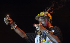 In this file photo taken on August 17, 2008 Jamaican 72-year-old musican Lee Scrath Perry and his reggae band perform on the world stage on the Hajogyar (Shipyard) Island in Budapest on the last day of the week-long Sziget festival in the Hungarian capital. Lee 