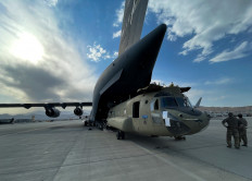 A CH-47 Chinook helicopter is loaded onto a US Air Force C-17 Globemaster III transport plane at Hamid Karzai International Airport in Kabul, Afghanistan, August 28, 2021. The Chinook is one of the pieces of equipment returning to the US as the military mission in Afghanistan comes to an end. 