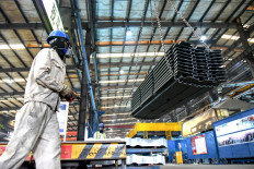 A worker transfers materials at a factory in Lianyungang in China's eastern Jiangsu province on Aug. 27, 2021.