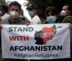 Separated, but together: Two Afghan refugees show solidarity with their compatriots back home.
