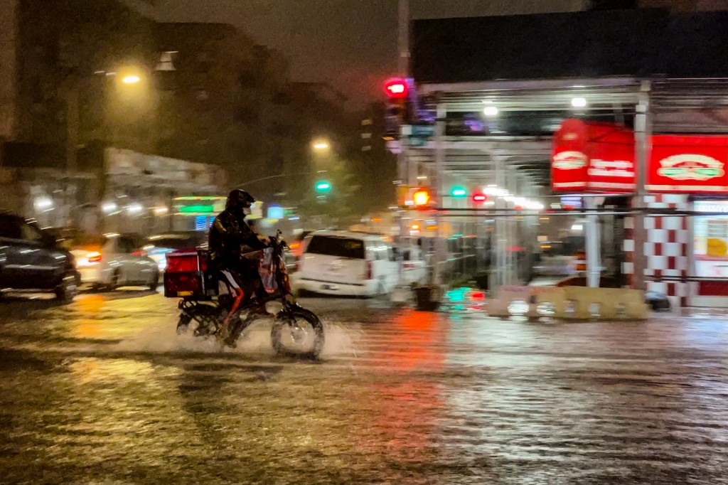 A delivery worker makes their way in the rainfall from Hurricane Ida during a flood on Intervale Avenue on September 1, 2021, in the Bronx borough of New York City. The once category 4 hurricane passed through New York City, dumping 3.15 inches of rain in the span of an hour at Central Park.