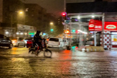 A delivery worker makes their way in the rainfall from Hurricane Ida during a flood on Intervale Avenue on September 1, 2021, in the Bronx borough of New York City. The once category 4 hurricane passed through New York City, dumping 3.15 inches of rain in the span of an hour at Central Park. 