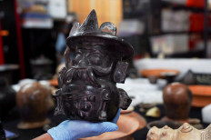Archaeologist Sergio Gomez displays a pot shaped in the image of storm god Tlaloc, found inside a 2,000-year-old tunnel built under the ornate Feathered Serpent Pyramid, which Gomez believes recreated the underworld and was used to initiate new rulers among other religious rituals, in the ruins of Teotihuacan, in San Juan Teotihuacan, Mexico August 12, 2021. 