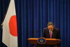 In this file photo taken on December 25, 2020, Japan's Prime Minister Yoshihide Suga bows after a press conference on the Covid-19 coronavirus in Tokyo. Japan's Prime Minister Yoshihide Suga said September 3, 2021 he will not run for re-election as party leader in a vote this month, effectively ending his tenure, according to public broadcaster NHK.

