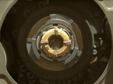 In this image released by NASA Perseverance rover shows a sample tube with its cored-rock contents inside, the bronze-colored outer-ring is the coring bit, the lighter-colored inner-ring is the open end of the tube, and inside is a rock core sample slightly thicker than a pencil, September 1, 2021. NASA's Perseverance rover succeeded in its second attempt to scoop up a piece of Martian rock for future analysis by scientists on Earth -- probably.
