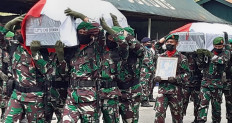 This handout photo taken and released by the Indonesian Military (TNI) on Sept. 3, 2021 shows soldiers carrying coffins of comrades in Sorong, in Indonesia's Papua region after at least four soldiers were killed and two others wounded in an ambush by guerillas on a military outpost.