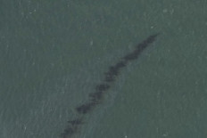 This National Oceanic and Atmospheric Administration(NOAA)/GOES satellite handout image shows an oil slick off the coast of Louisiana after the passing of Hurricane Ida on September 1, 20201. Workers have deployed containment booms and skimmer devices as they attempt to contain a sizable oil spill in the Gulf of Mexico discovered after Hurricane Ida roared through the area, the US Coast Guard said on September 5, 2021.