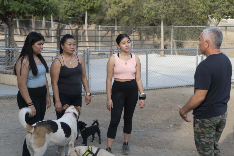 Know thyself: Cesar Millan speaks to three clients and their canine companions at his Dog Psychology Center in Santa Clarita, California. Courtesy of the National Geographic Channel.