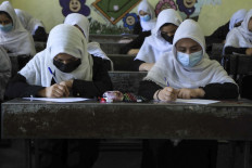 Schoolgirls attend class in Herat on August 17, 2021, following the Taliban stunning takeover of the country. 