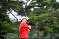 This picture taken on August 30, 2021 shows South Korean golfer Pak Se-ri teeing off as it drizzles during a practice round at the Silk River Country Club golf course in Cheongju.