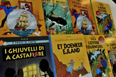 A picture taken on January 24, 2014 shows covers of comics series Tintin translated in several languages at the Casterman publisher headquarters in Brussels.