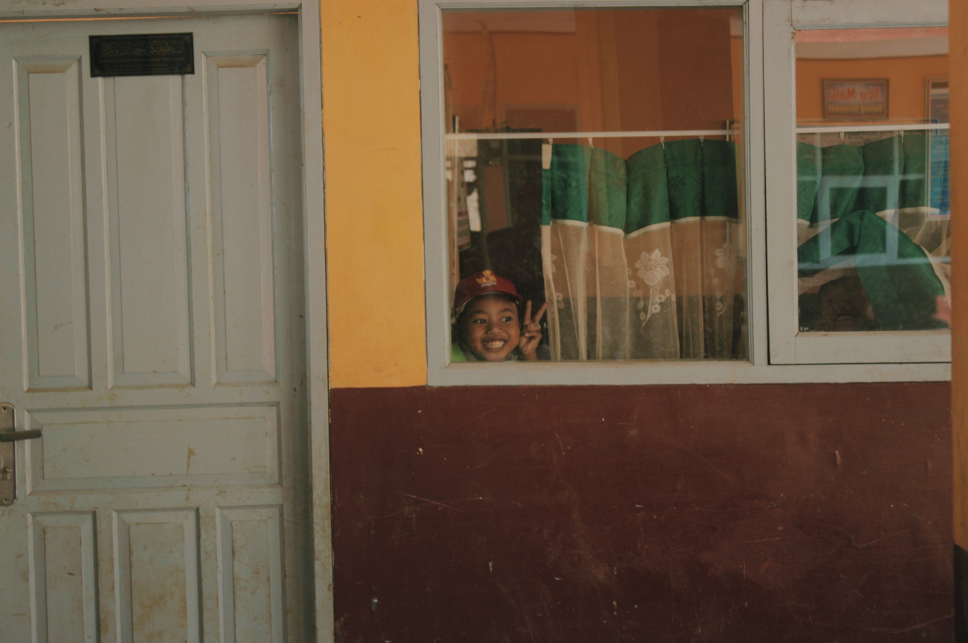 A student poses at a school in Cihawuk, Bandung. (Unsplash/Courtesy of Muhammad Ridzky Ramadhani)