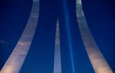 The 'Tower of Light,' a beam of light that pays tribute to those killed during the September 11, 2001 attacks at the Pentagon, illuminates the sky over the Pentagon as seen from the US Air Force Memorial in Arlington, Virginia, September 9, 2021, ahead of the 20th anniversary of the attacks. 