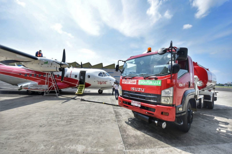 A Pertamina tanker truck pumps bioavtur J2.4 into a CN235-220 turboprop plane on Sept. 6, 2021, for a ground test at an identified airfield in Bandung, West Java, in this handout photo.
