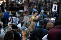 The photo of a 9/11 victim is carried by family and friends as they attend a ceremony commemorating the 20th anniversary of the 9/11 attacks on the World Trade Center on September 11, 2021 in New York City.