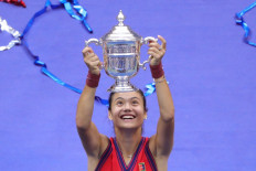 Britain's Emma Raducanu celebrates with the trophy after winning the 2021 US Open Tennis tournament women's final match against Canada's Leylah Fernandez at the USTA Billie Jean King National Tennis Center in New York, on September 11, 2021. 